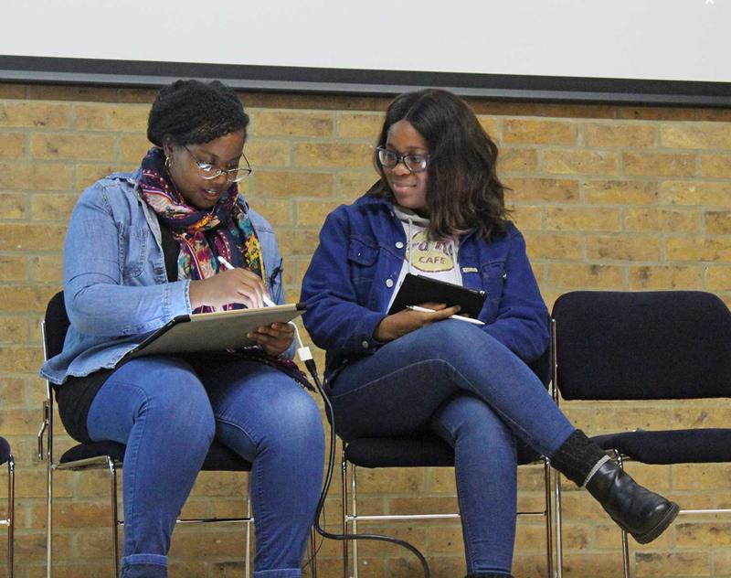 Two Oxford students using Canvas on their tablets.